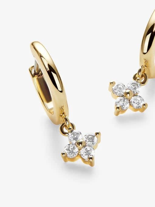 Gold huggie hoop earrings with cubic zirconia stars on a stainless steel post.