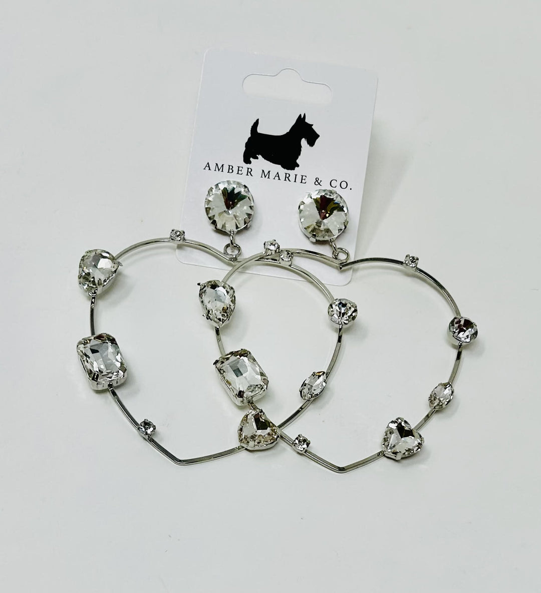 Heart-shaped earrings with crystal accents in a silver-tone finish.