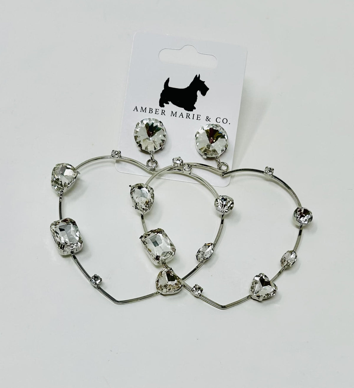 Heart-shaped earrings with crystal accents in a silver-tone finish.