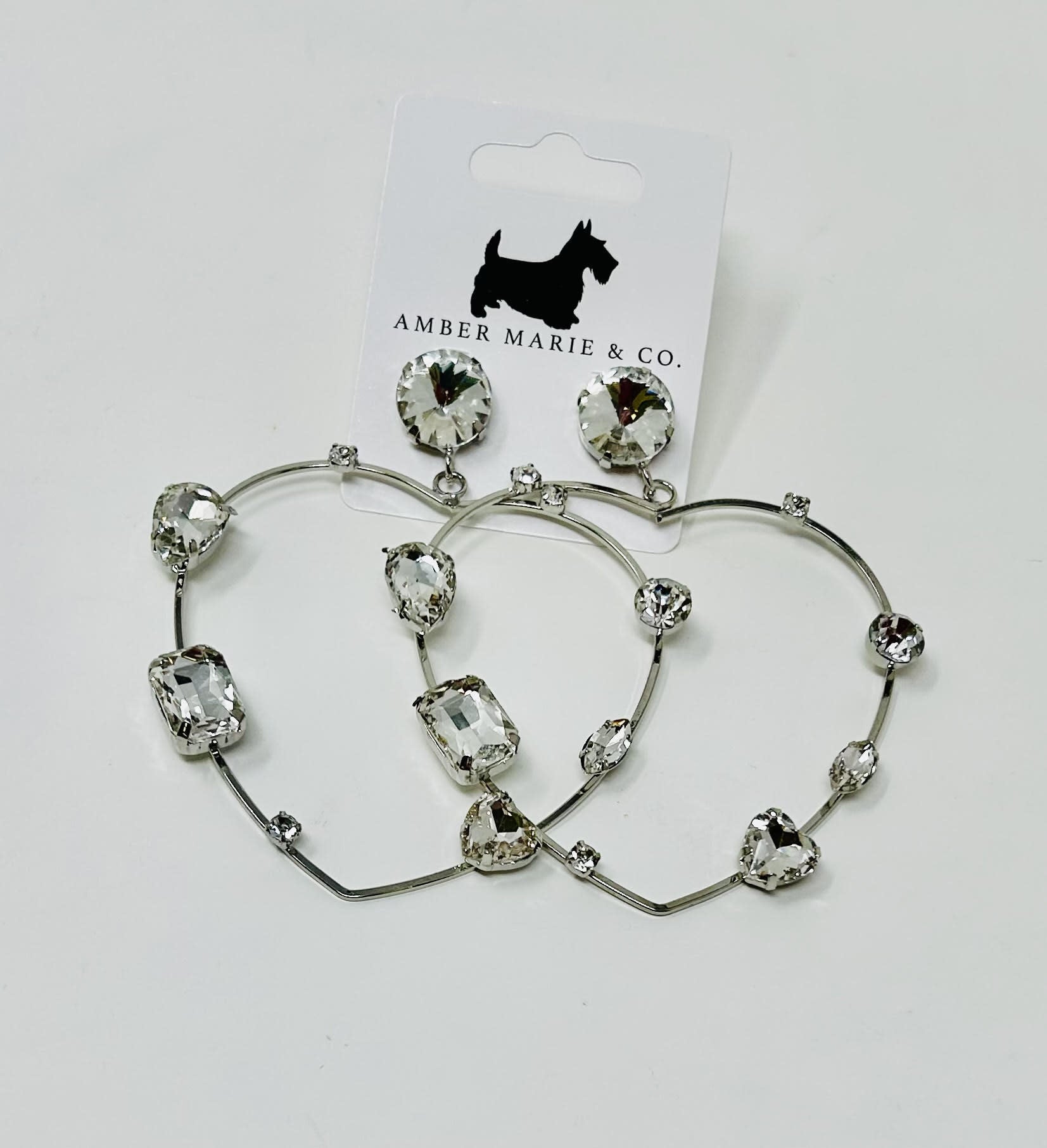 Heart-shaped earrings with crystal accents in a silver-tone finish.