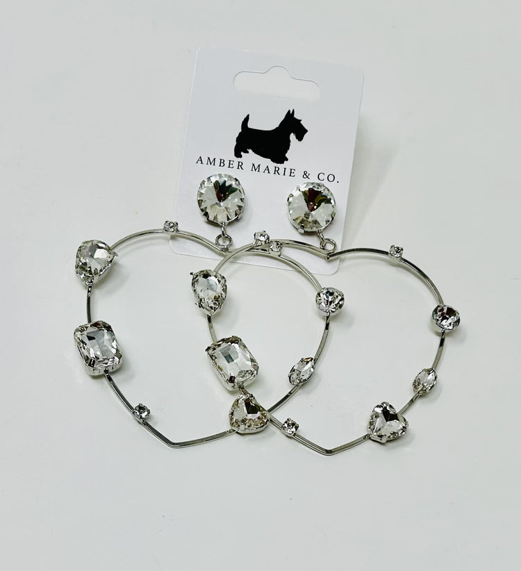 Heart-shaped earrings with crystal accents in a silver-tone finish.