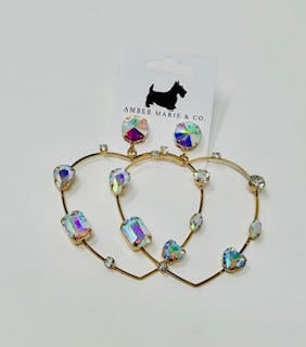 Heart-shaped earrings featuring white crystals set in a silver-tone metal frame.