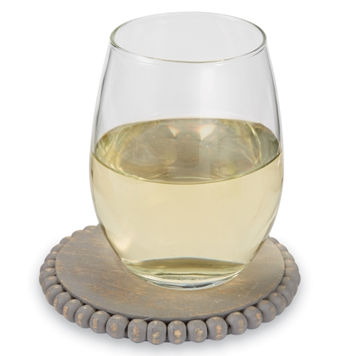 Beaded wood coaster with natural grain finish and intricate decorative beadwork pattern.