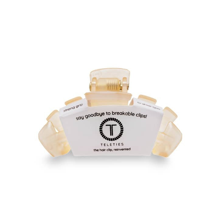 Tiny hair clip with bendable teeth in a neutral tone