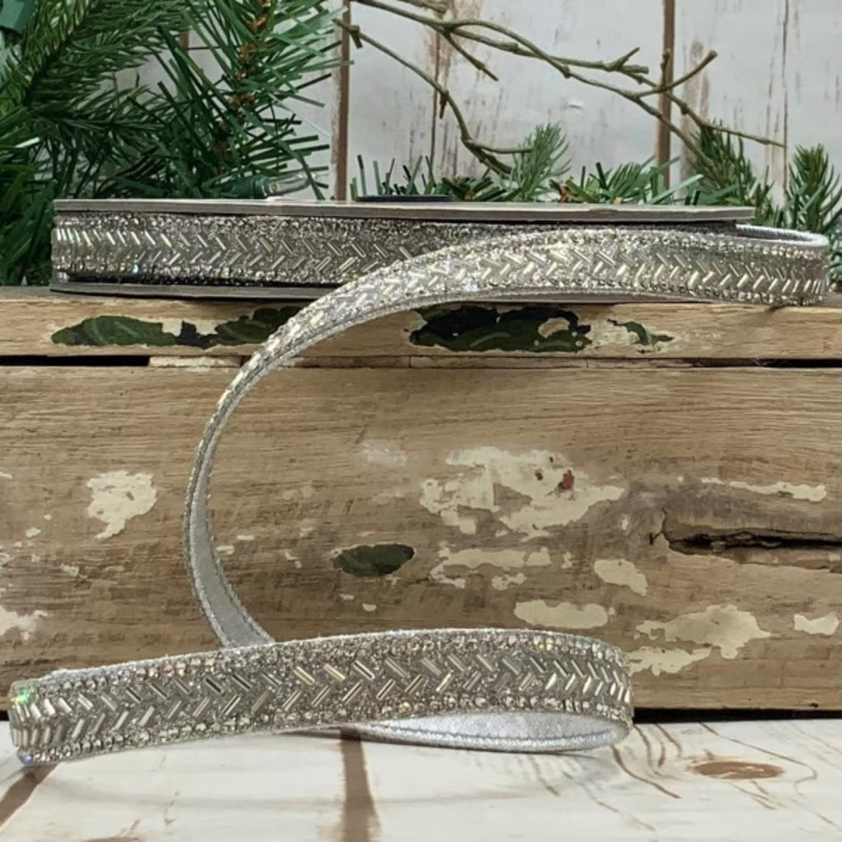 Silver chevron-patterned beaded ribbon on a spool, measuring 0.5 meters by 9 meters.
