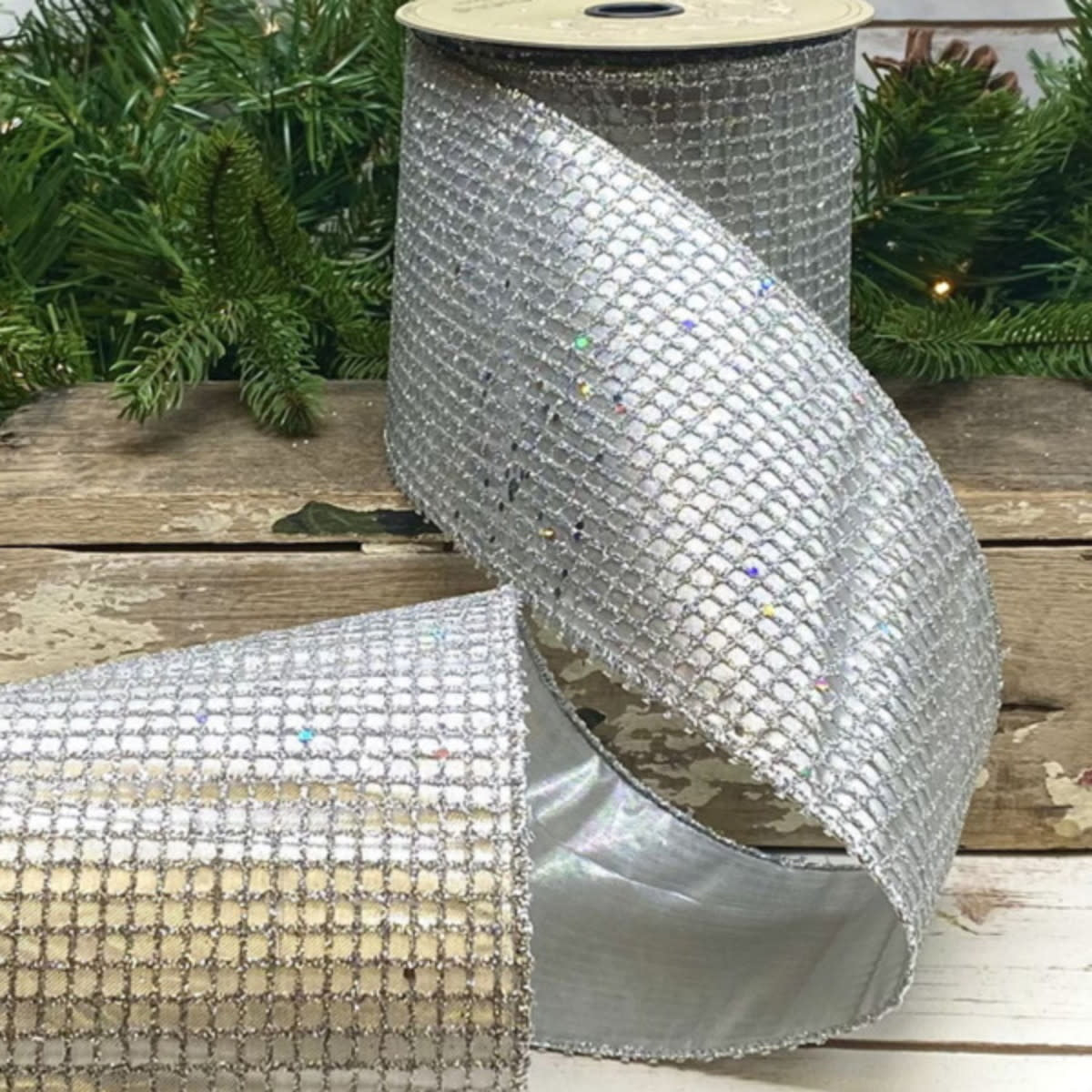 4-inch wide platinum metallic glitter mesh fabric roll with shimmering silver finish.