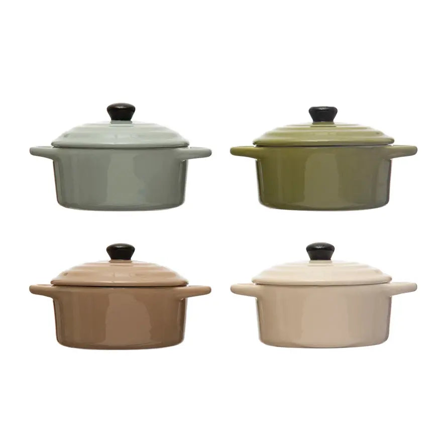 Four stoneware mini bakers with lids in sage, olive, tan, and cream, each with two side handles.