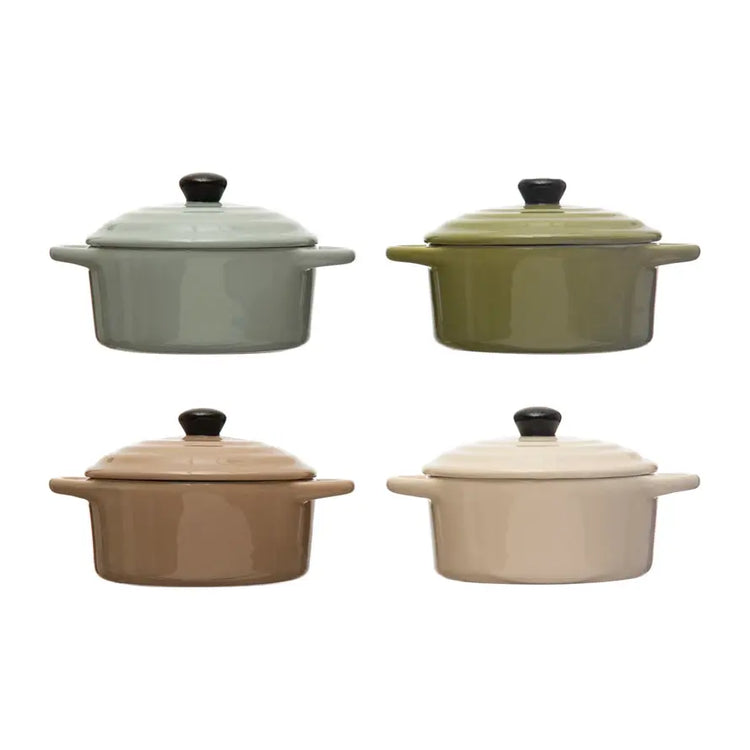 Four stoneware mini bakers with lids in sage, olive, tan, and cream, each with two side handles.