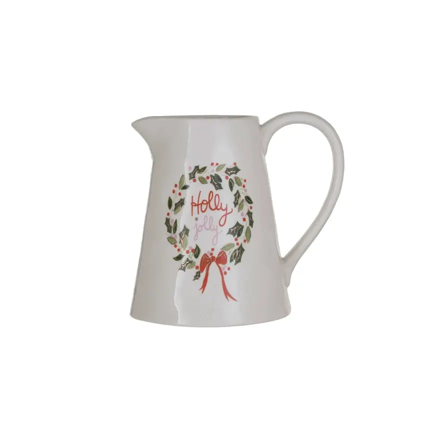 White stoneware pitcher with a holly wreath design and Holly Jolly text, 6.5 inches tall.