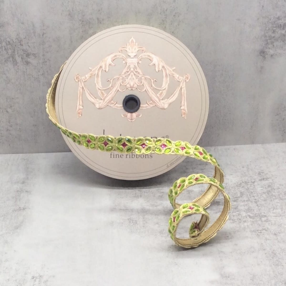 Lime green and gold metallic ribbon with pink jewel accents on a spool.
