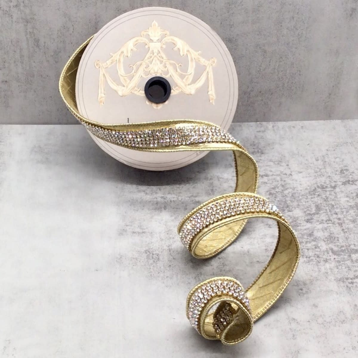 Gold metallic ribbon with a central row of clear rhinestones on a spool.