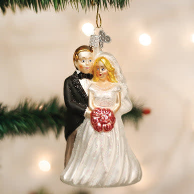 Bridal couple ornament featuring a bride in white dress and groom in formal attire as wedding keepsake