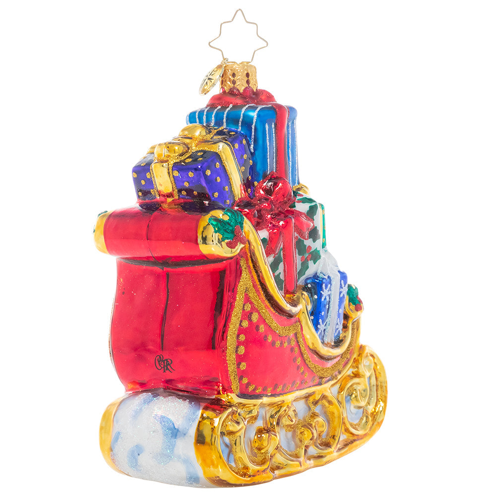 Gold gilded sleigh ornament filled with colorful Christmas presents