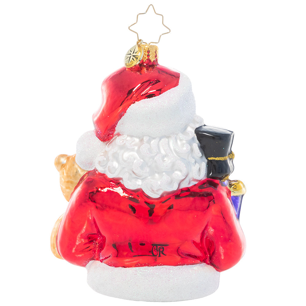 White ceramic Santa figurine holding red gifts with a smiling face.