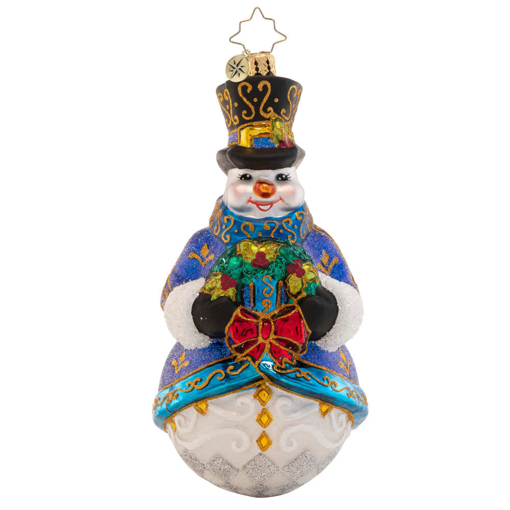Ornately-glittered white snowman figurine wearing a winter coat and top hat holding a gift.