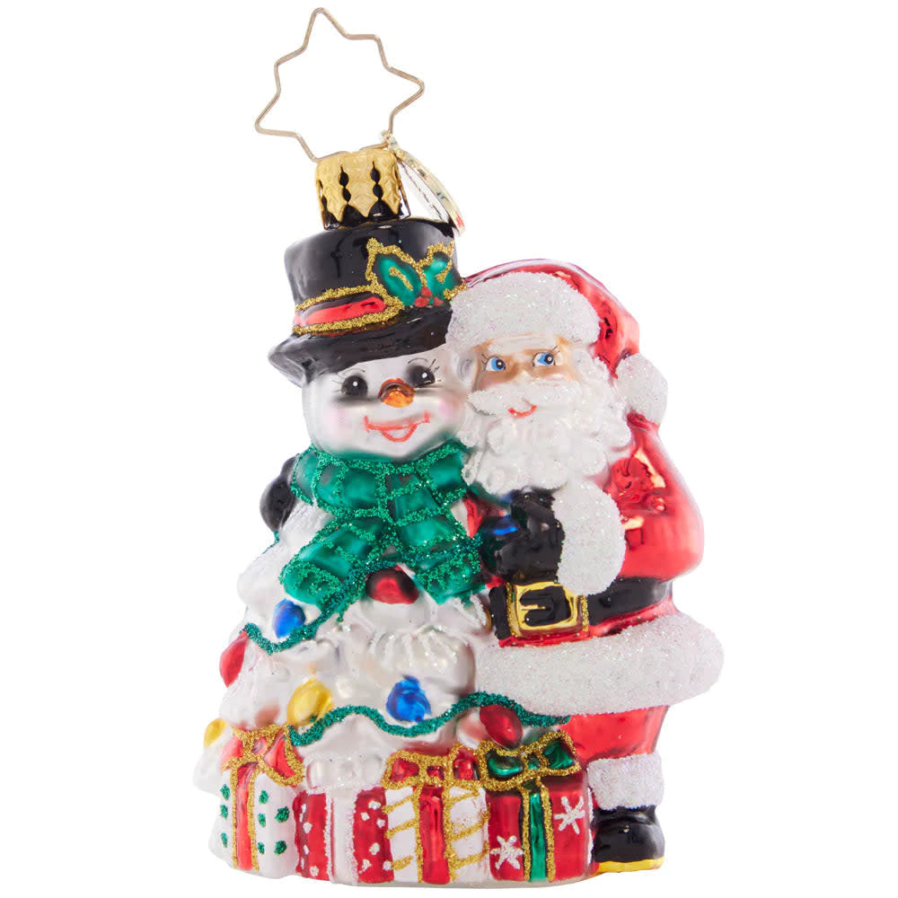 Frosty Duo Gem ornament featuring a smiling Santa and snowman surrounded by wrapped gifts and Christmas lights.