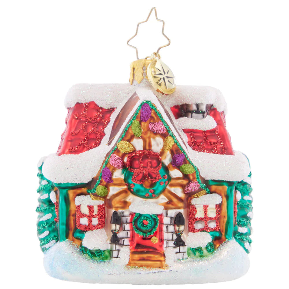 Miniature cottage figurine with snow-covered roof in deep blue tones.