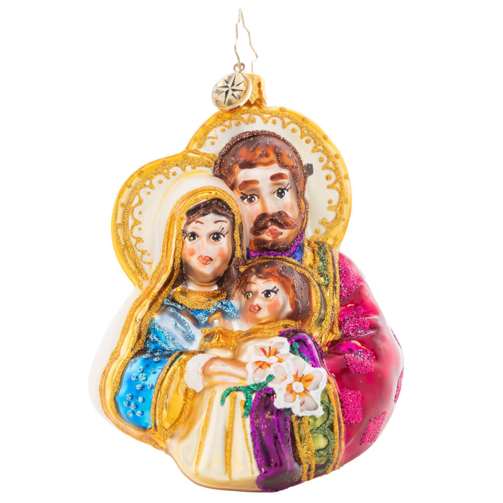 Wooden figurine of Mary and Joseph cradling baby Christ in a nativity scene.