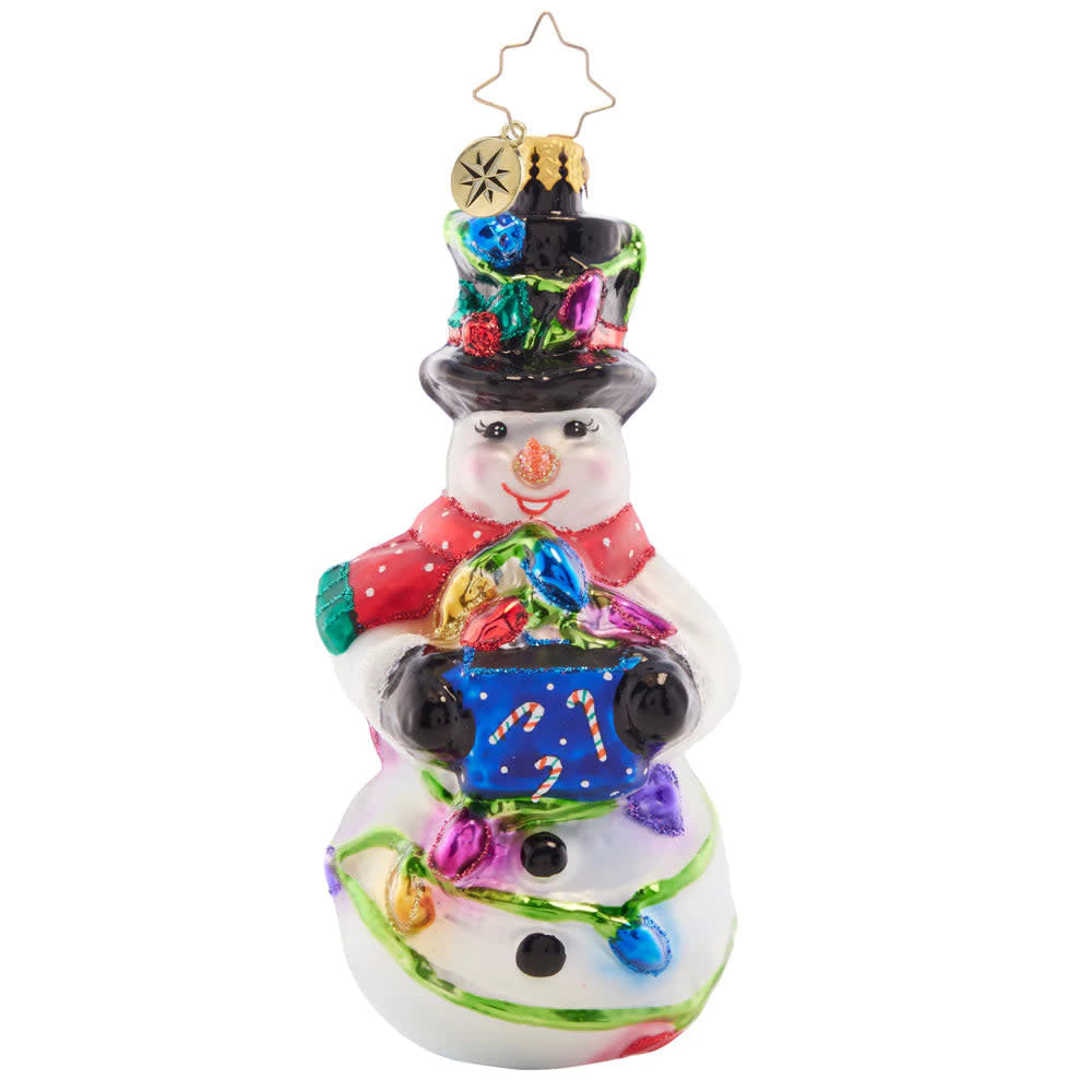 Smiling snowman figurine holding a bundle of colorful holiday lights.