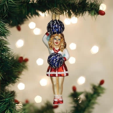 Red cheerleader ornament with pom-poms in a classic standing pose.