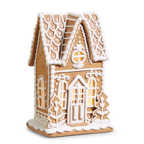 10.5-inch clay dough gingerbread house with white icing details and warm interior lighting.
