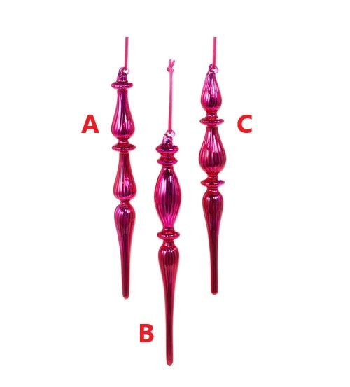 Three pink glass finial ornaments with ribbed textures and elongated, tapered silhouettes.