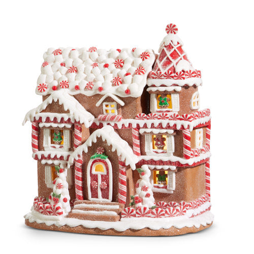 11-inch lighted clay dough gingerbread house decorated with peppermint candies and white icing.