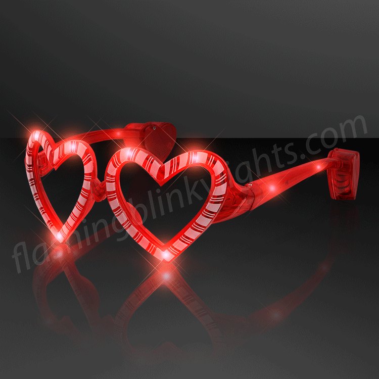 Red heart-shaped novelty glasses with candy cane stripes featuring a built-in LED light.