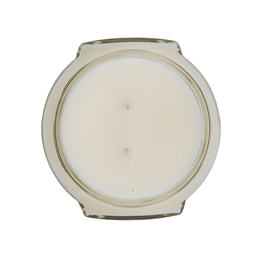 Top-down view of an 11oz Tyler candle in a clear glass jar with two wicks and white wax.