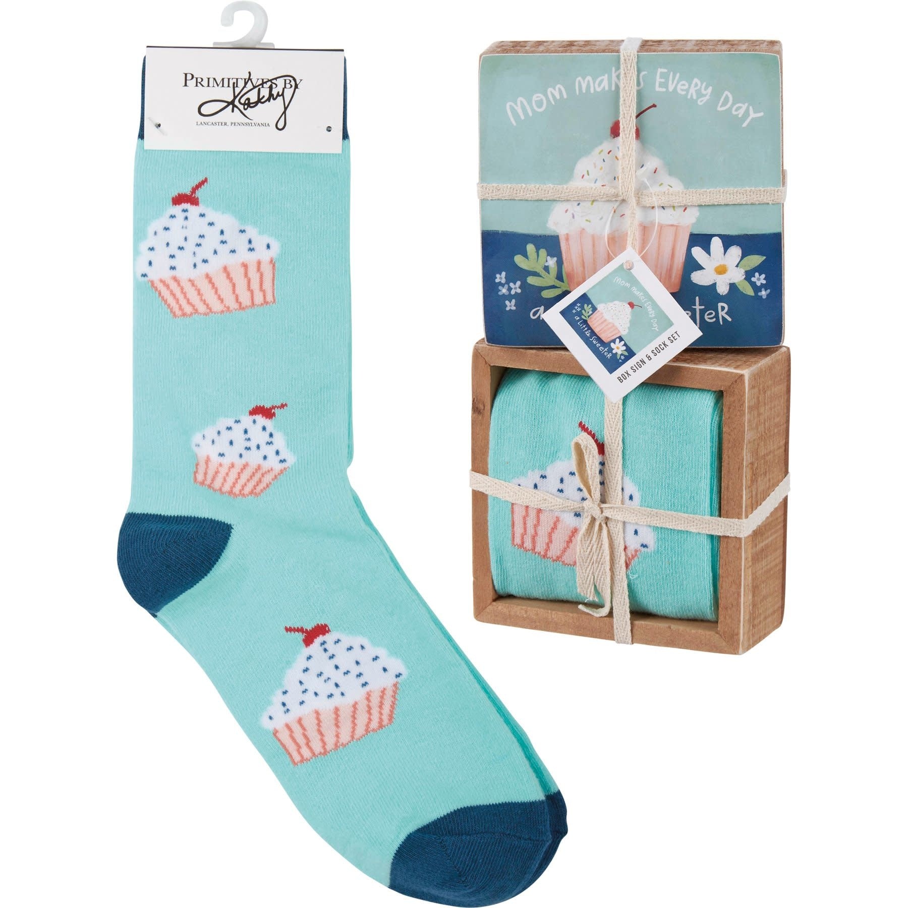 Wooden box sign with hand-painted cupcake flower reading Mom Makes Every Day A Little Sweeter holding rolled cotton nylon spandex socks.
