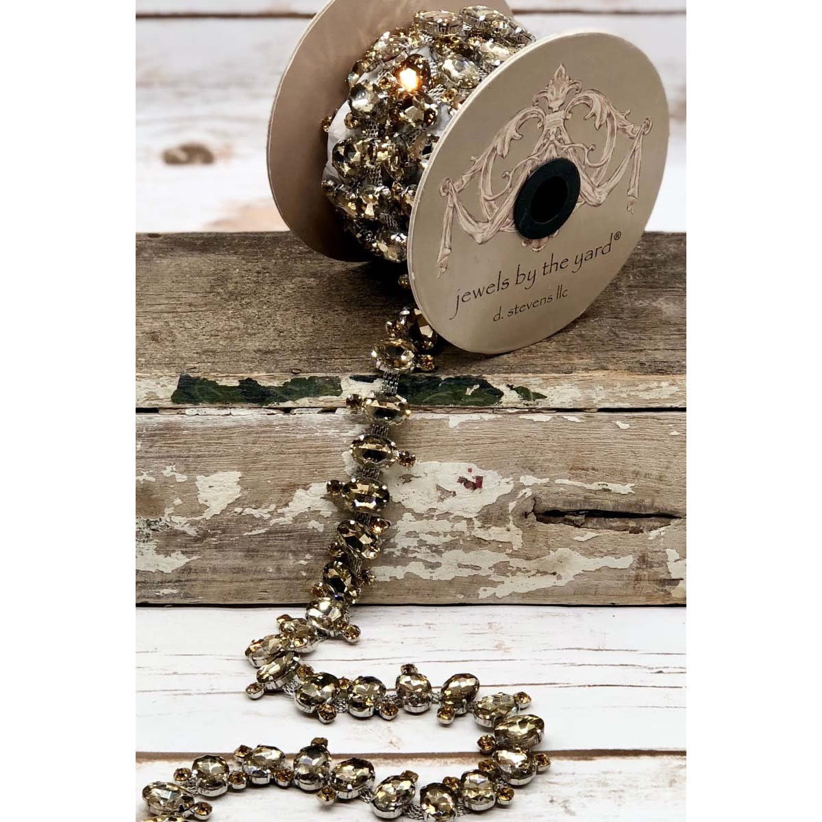 One yard of large oval smoke-colored stones with a subtle ribbon decoration.