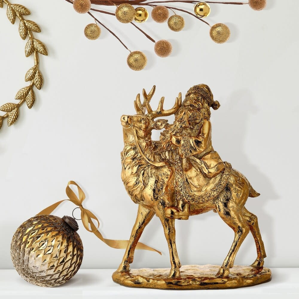 12-inch gold resin Santa Claus riding a deer figurine with intricate textured details.