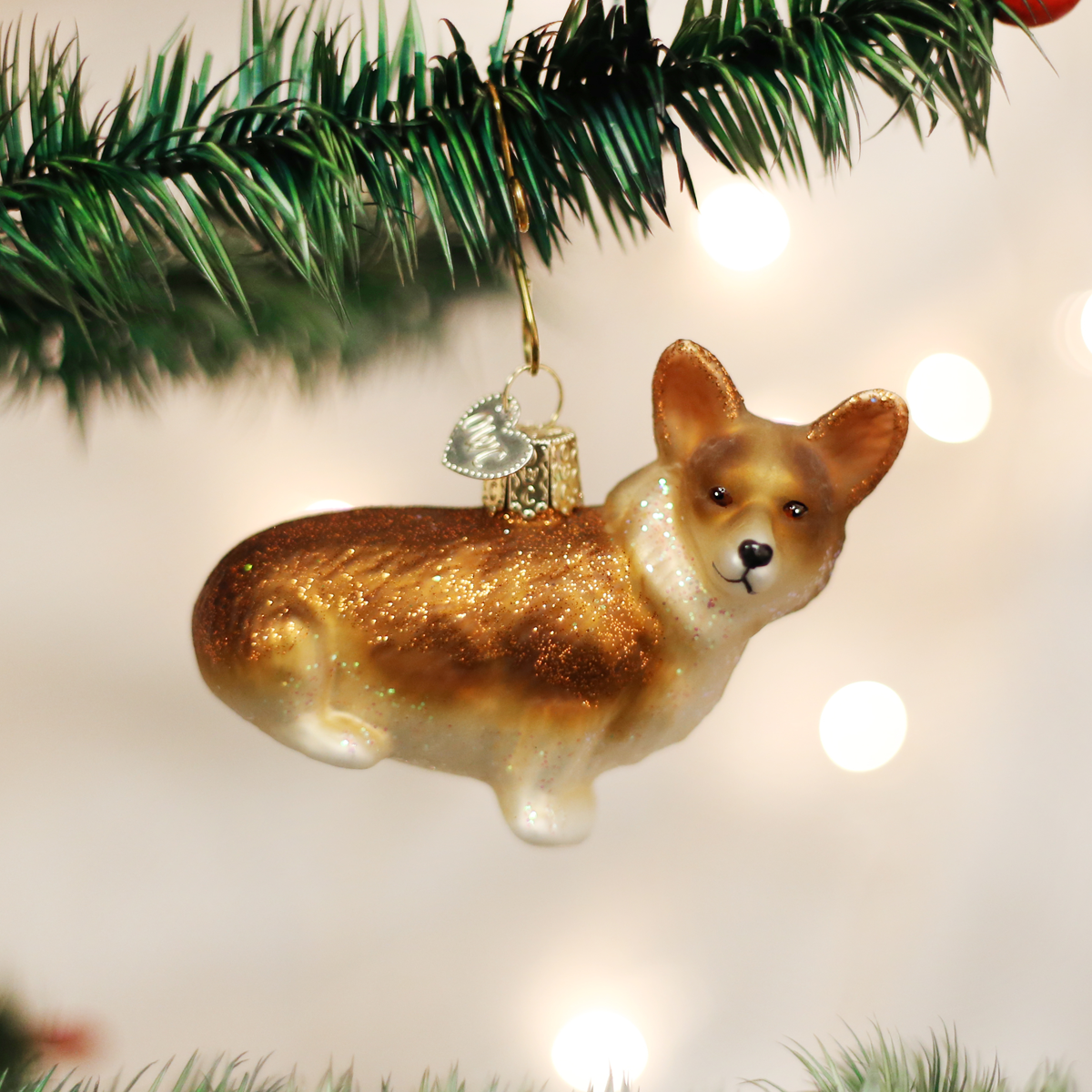 White ceramic Pembroke Welsh Corgi dog ornament with black ears and tail.