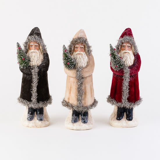 Resin Belsnickle figure in a long silver-tinsel coat holding an artificial Christmas tree.