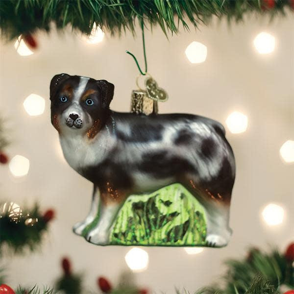 Australian Shepherd dog ornament in white resin with black markings.