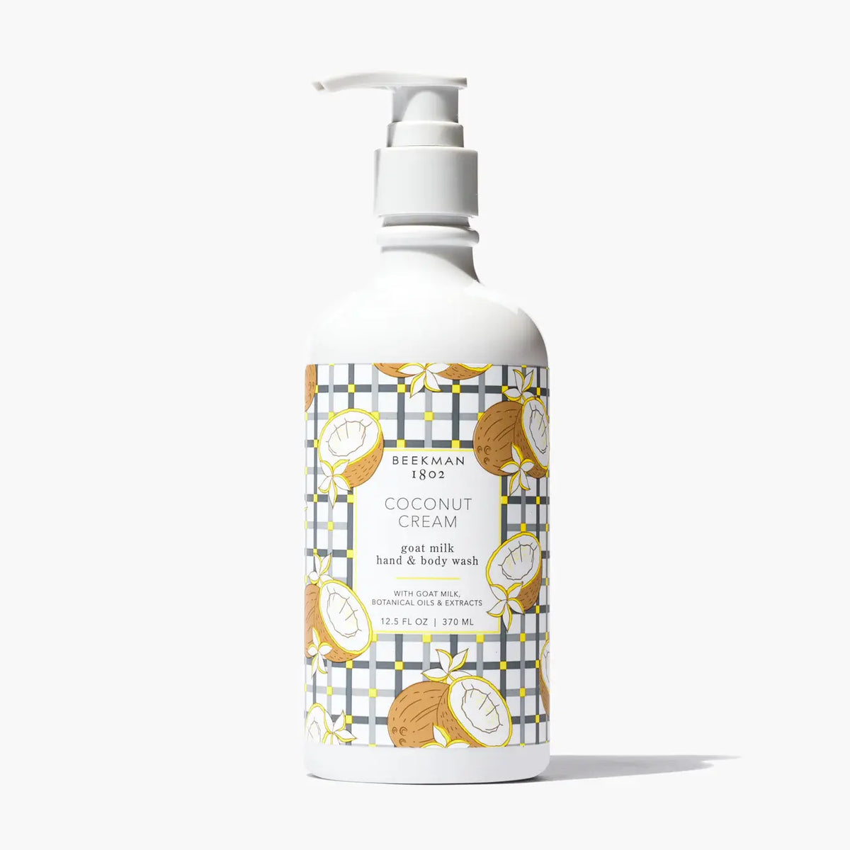 Beekman 1802 Coconut Cream goat milk hand and body wash in a white pump bottle with plaid pattern.