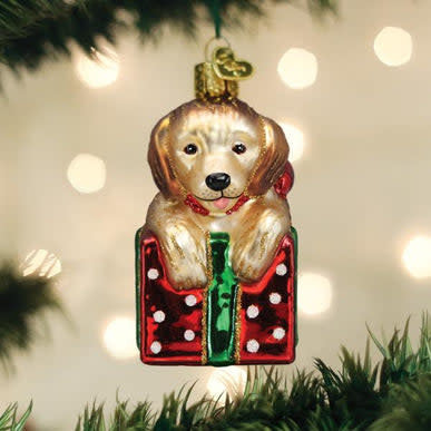 Golden puppy ornament with a surprised expression standing upright.