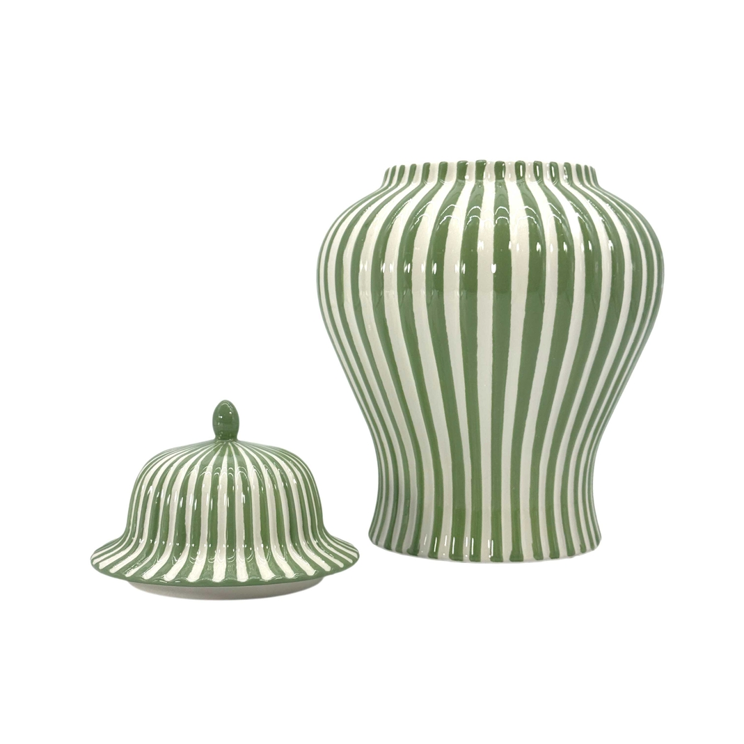 Green and white candy cane striped ceramic ginger jar with matching lid on a white background.