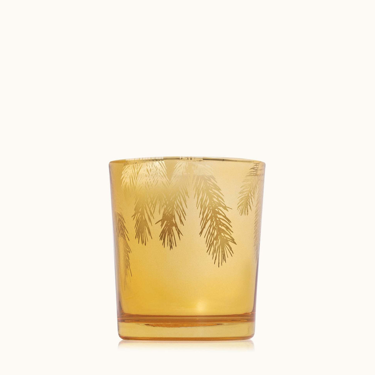 Gilded Frasier Fir poured candle in gold with etched pine needle pattern on a cylindrical silhouette.