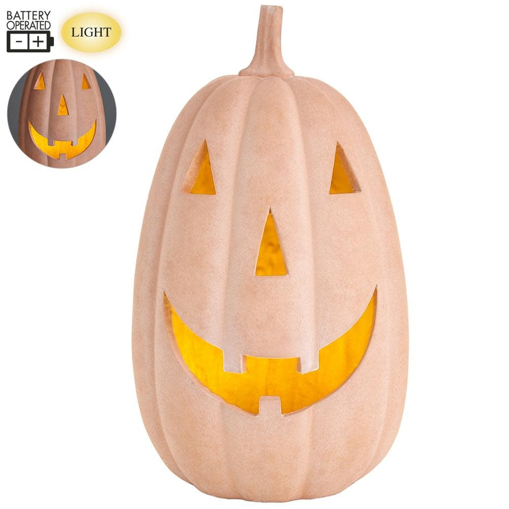 Terra cotta colored battery-operated jack-o-lantern with carved pumpkin face and warm LED light.