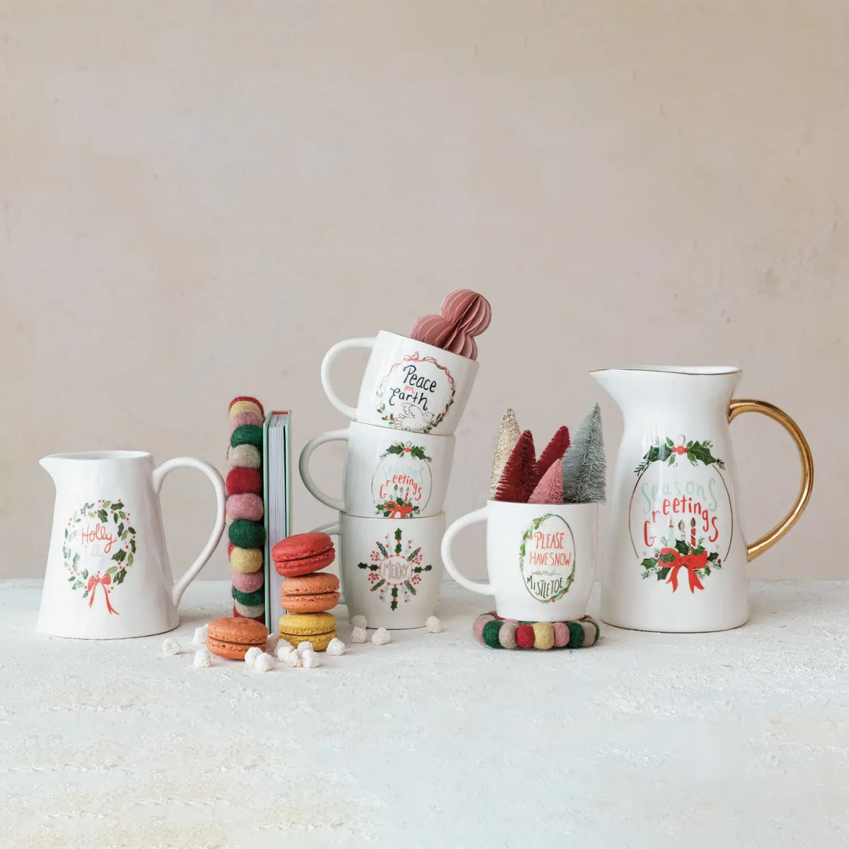 White stoneware mug with gold electroplated rim and festive holiday saying text