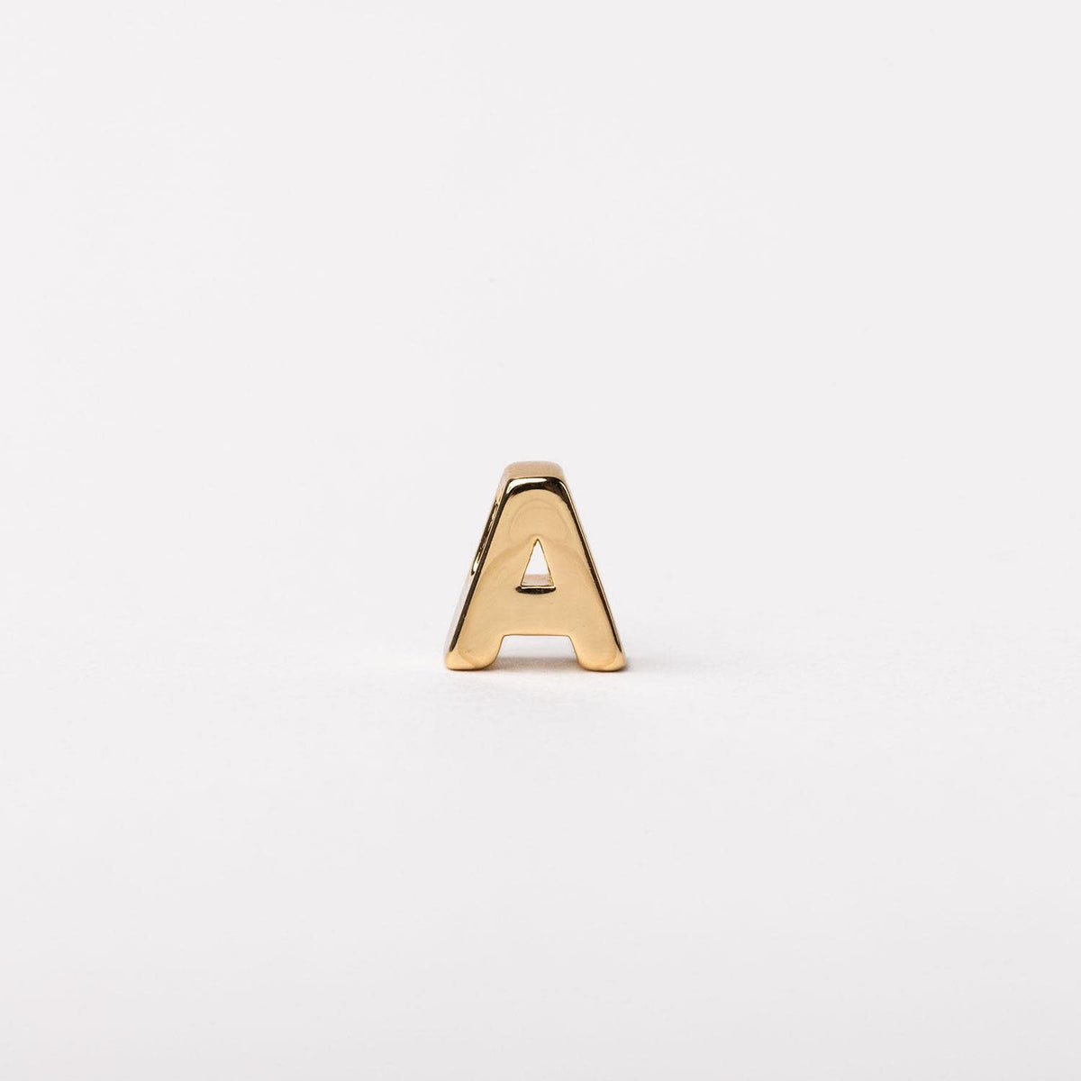 Gold-toned letter A charm with a polished finish on a plain white background.
