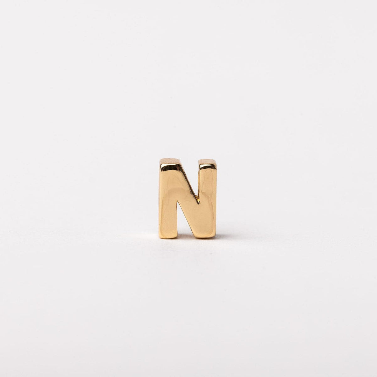 Gold-tone Charm Luxe bar necklace with a sleek rectangular pendant featuring subtle engraved detailing.