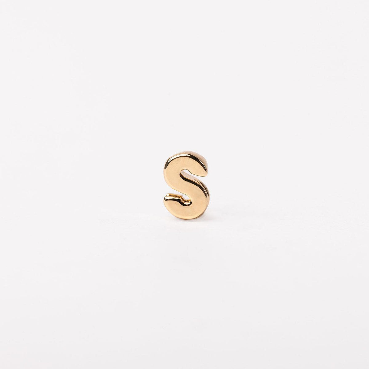 Gold-toned letter S charm with a smooth, rounded silhouette.