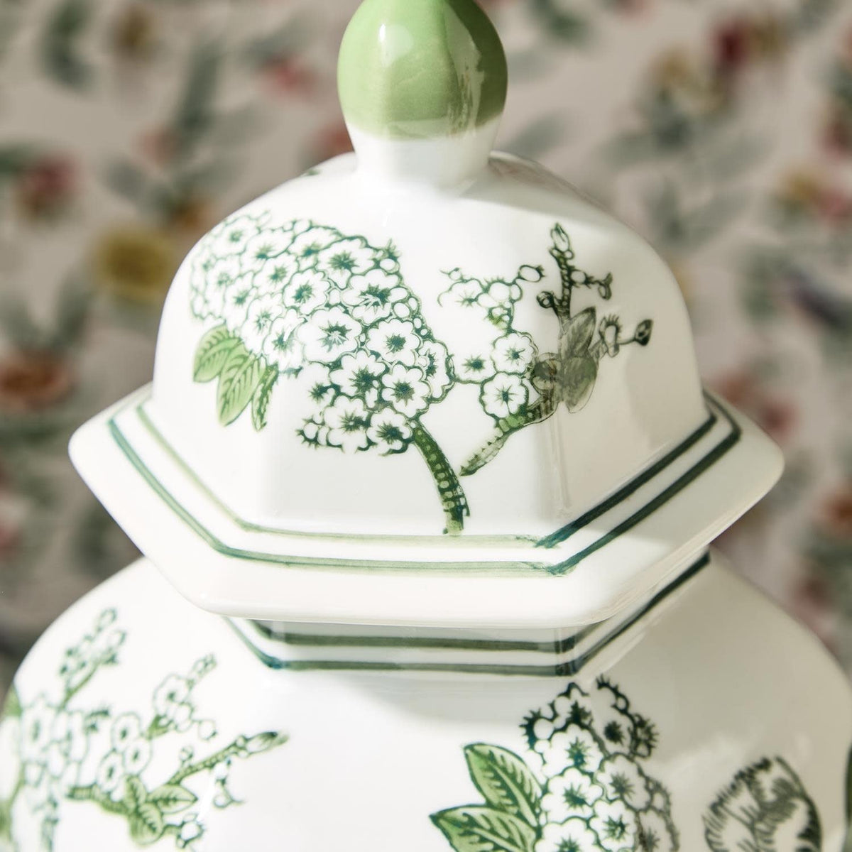 Hand-painted green and white porcelain hexagonal temple jar with lid featuring primrose and lotus chinoiserie pattern