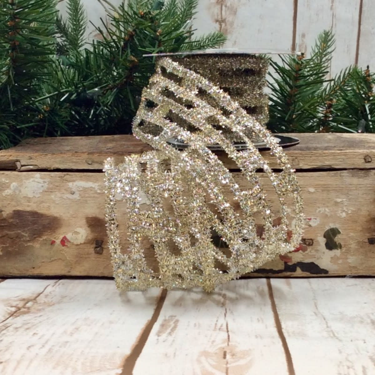 Gold and silver tinsel link stretch ribbon on a spool, 2.5 inches wide.