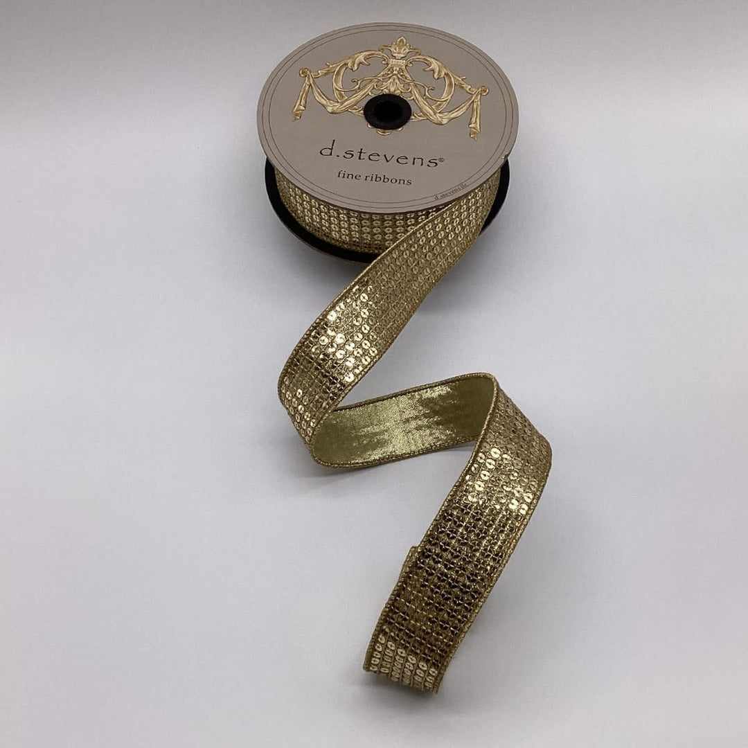 A roll of metallic gold flash sequin ribbon with a shimmering pattern.