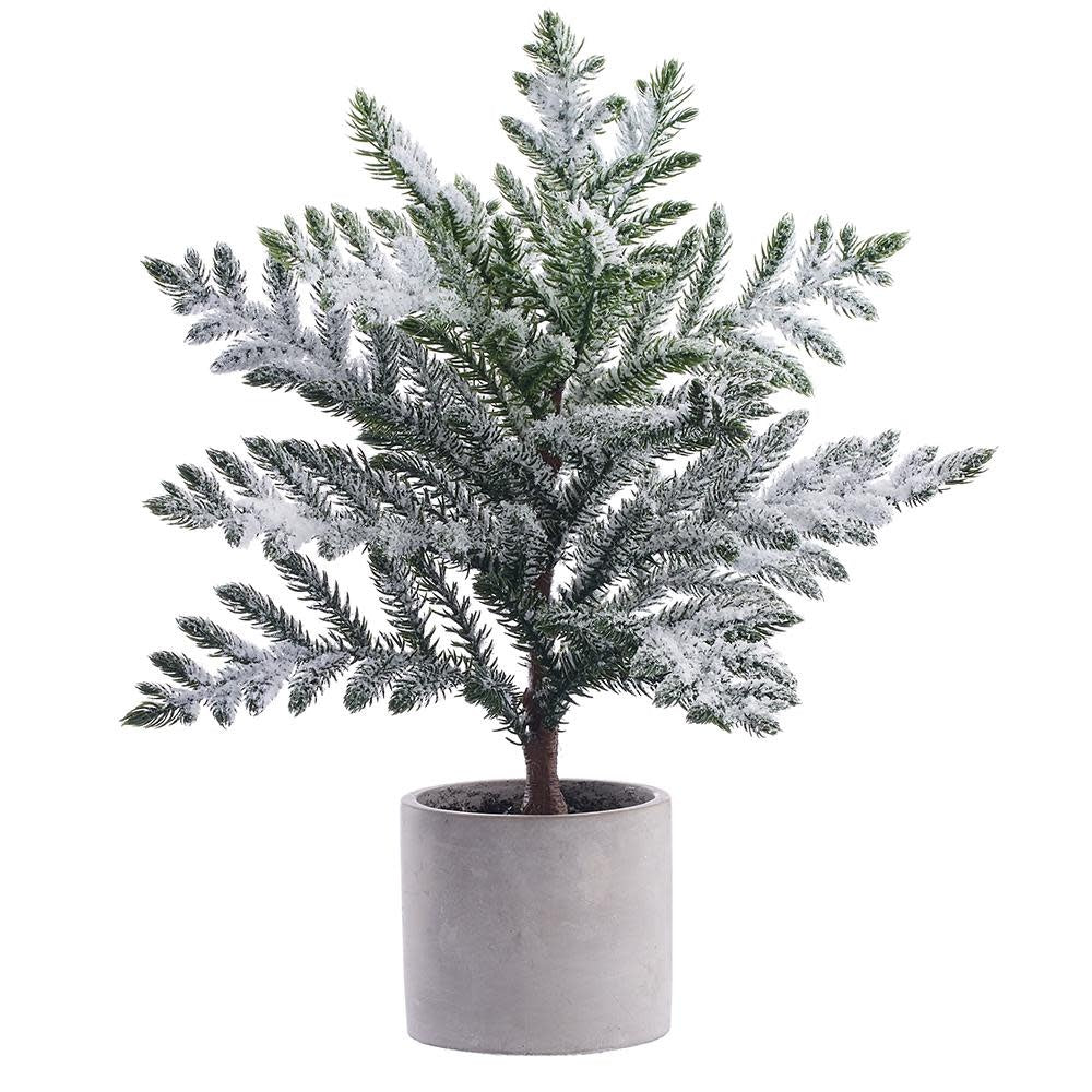 Festive artificial pine tree with white snow accents in a green cement pot