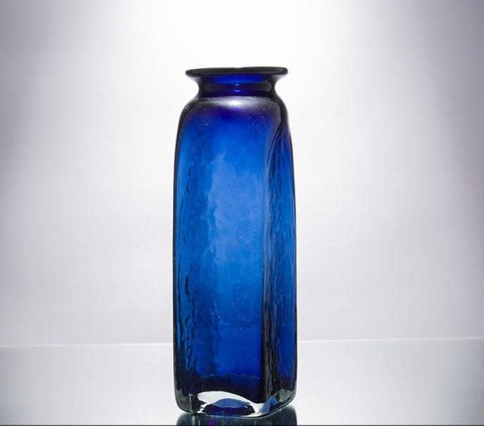 Tall clear glass vase with sleek cylindrical shape measuring 8.1 inches wide and 4.5 inches deep.