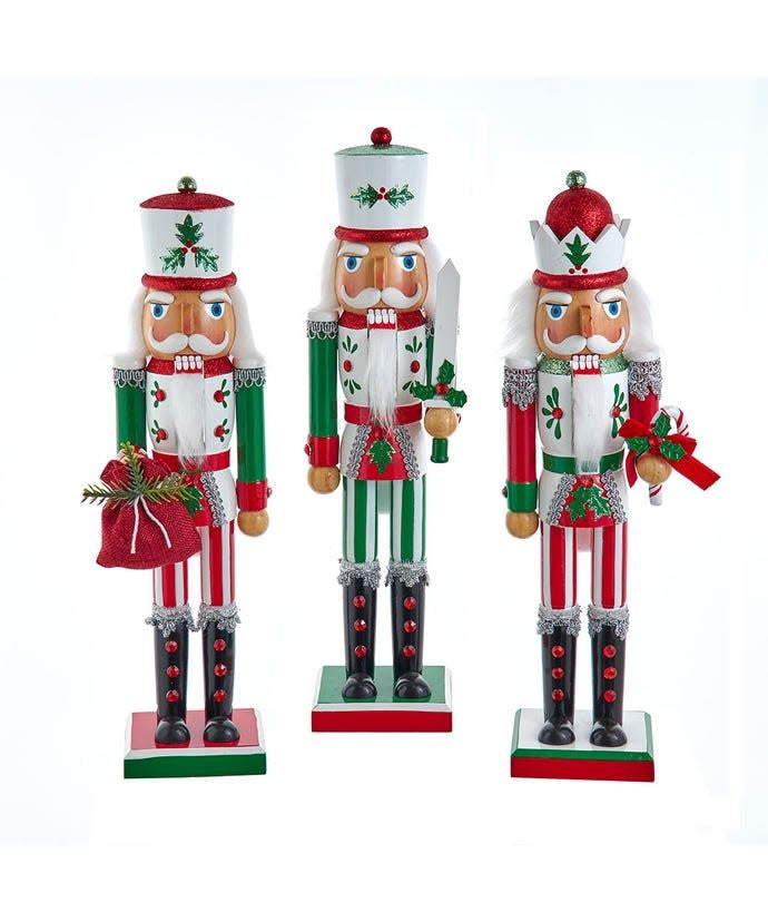 Wooden jolly nutcracker with red and green painted face, fabric hat, and whimsical expression.